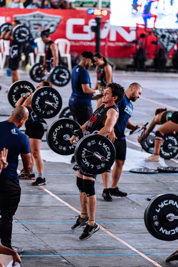 Intense CrossFit competition captures athletes lifting weights with focus and strength.